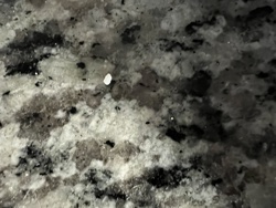 Unable to identify - possibly a fragment or dust particle